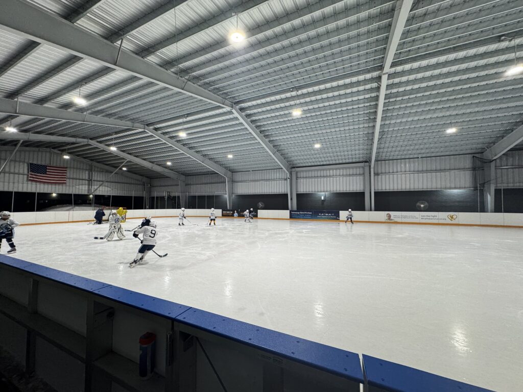 Nighttime hockey practice on the ice at Flexible Arena
